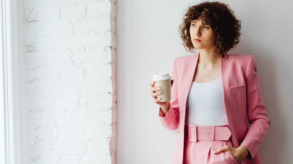 Woman in Her Pink Suit Holding a Coffee